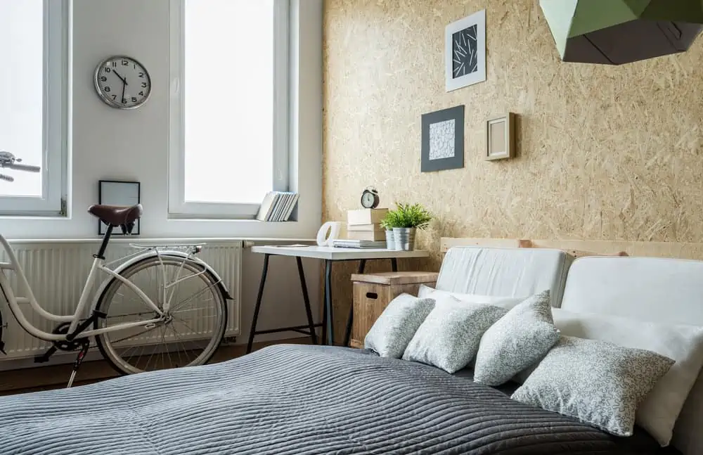 White city bicycle in bedroom with wooden wall