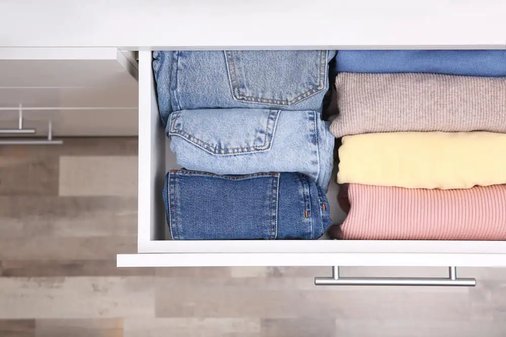 Open drawer with rolled up jeans.